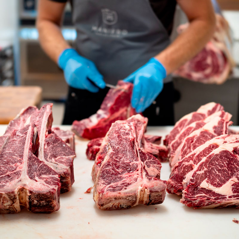 Dry Aged Steak macellaio che taglia dei pezzi di carne